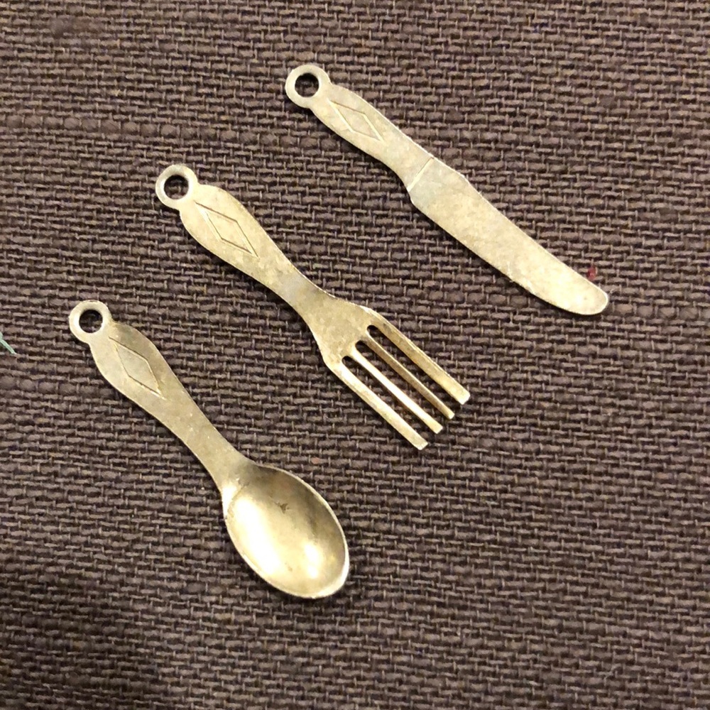 Knife, fork and spoon charms or pendants.